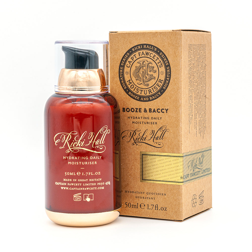 Red moisturizer bottle with gold cap and brown box labeled 'Ricky Hall' and 'Captain Fawcett' on a white background.