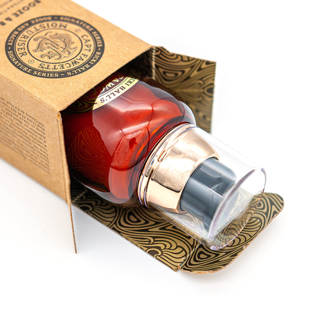 Red bottle with gold cap in a decorative box on a white background. Captain Fawcett Booze & Baccy Moisturiser 50ml With Tobacco And Spice Fragrance