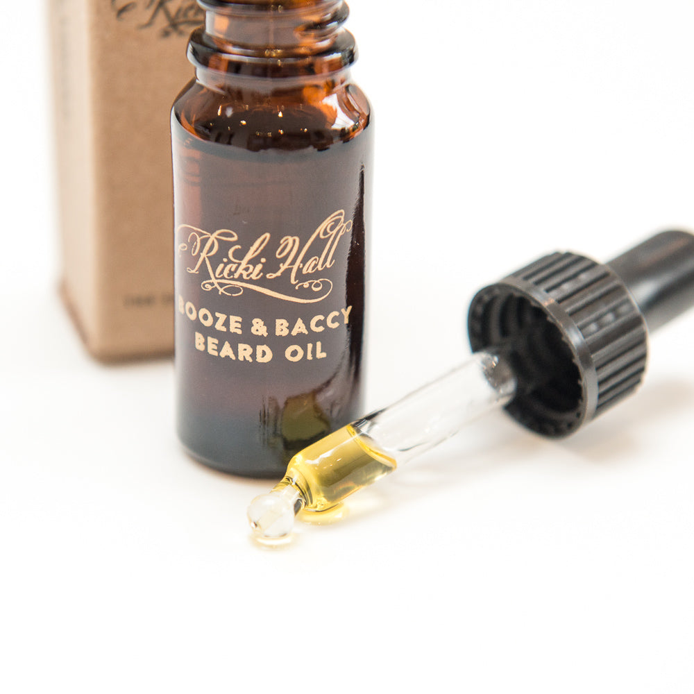 Brown glass bottle of Rikki Hill beard oil with dropper on a white background