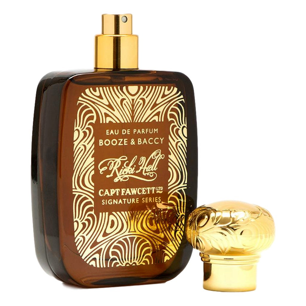 Perfume bottle with gold cap and intricate label on a white background