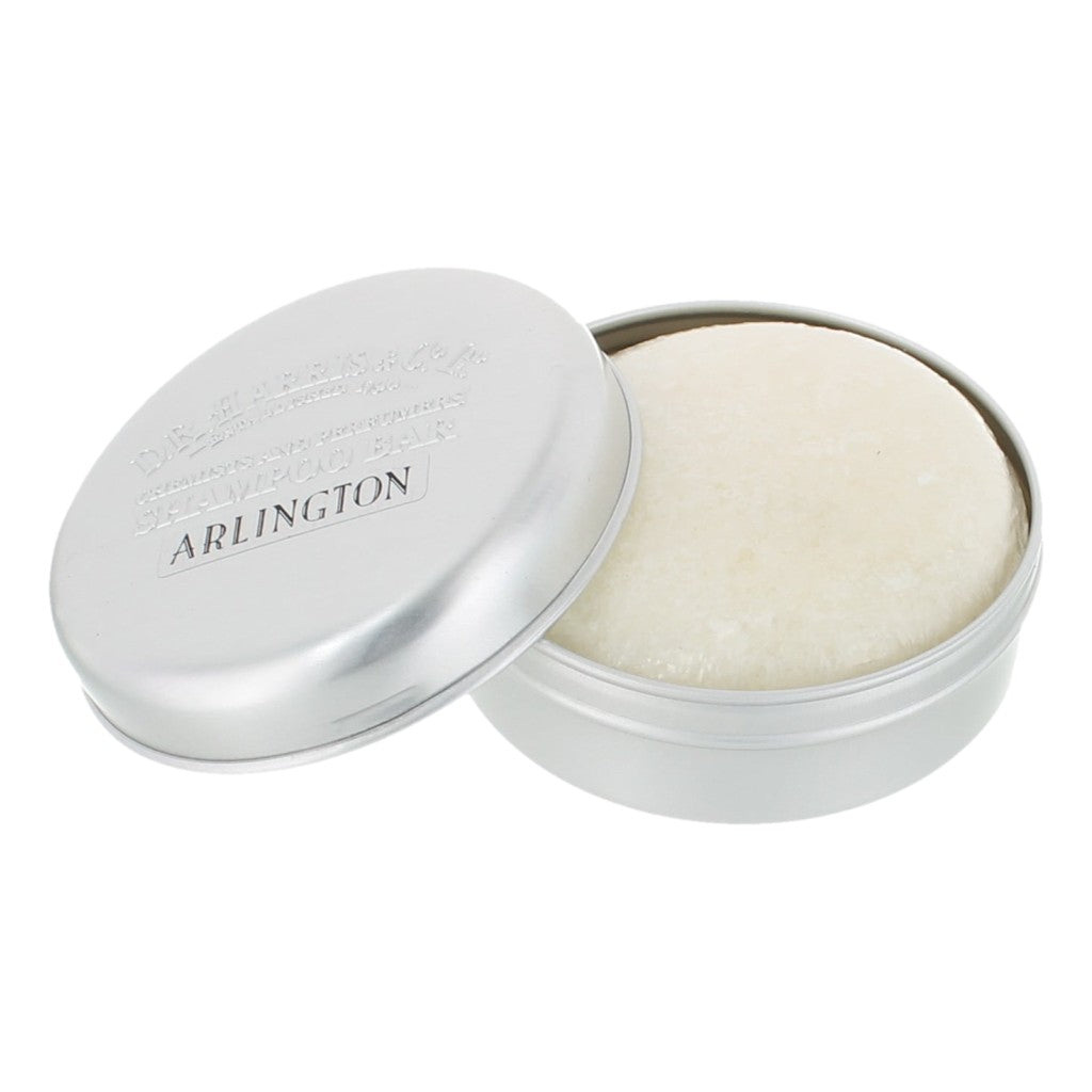 Silver container with solide shampoo bar inside, branded 'Arlington', on a white background