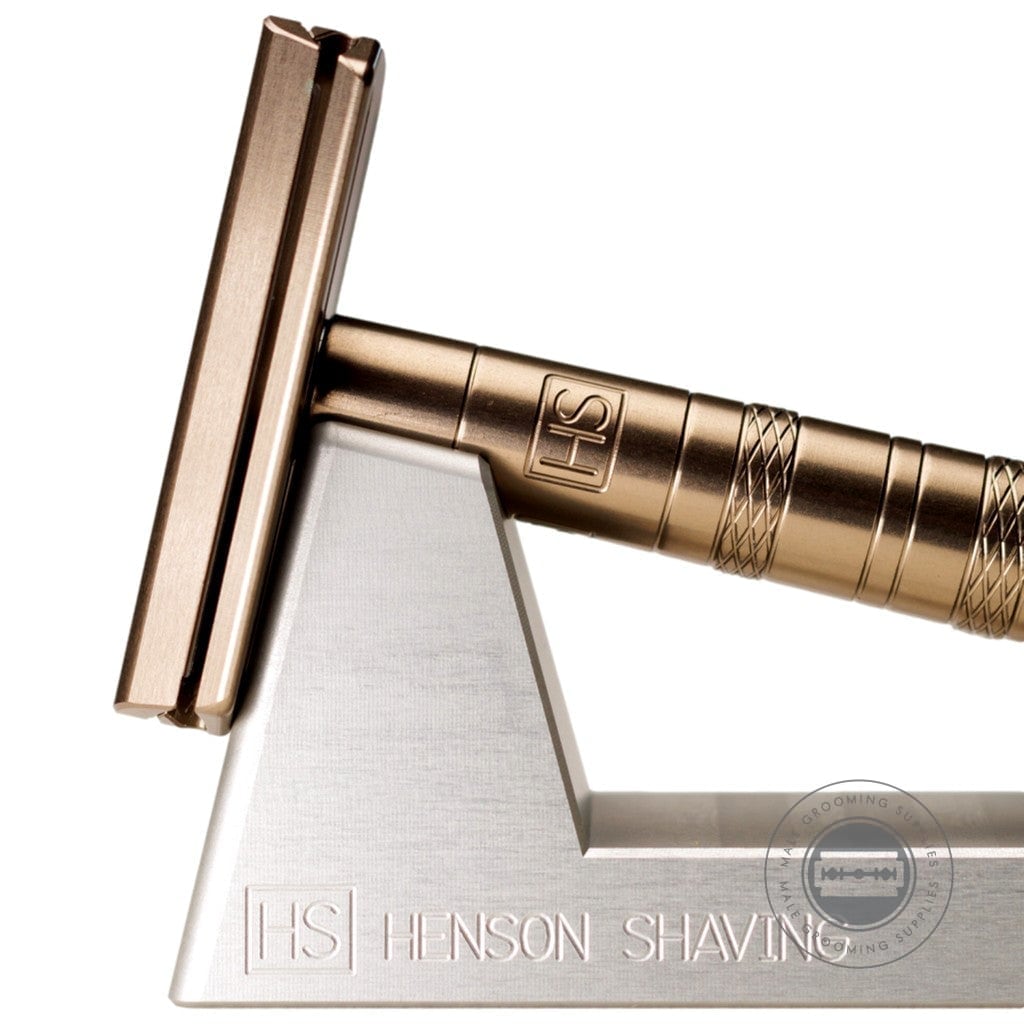 Close-up of the Henson AL13 Safety Razor V2.0 Tan Edition on stand, showcasing the sleek tan anodized finish and design.