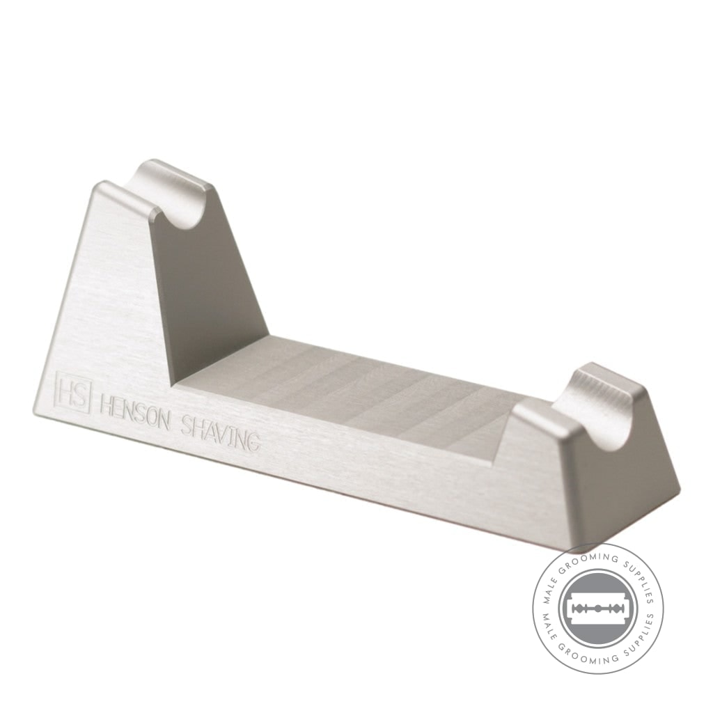 Angled view of the Henson Razor Stand, featuring engraved branding and a minimalist design for stylish razor storage.