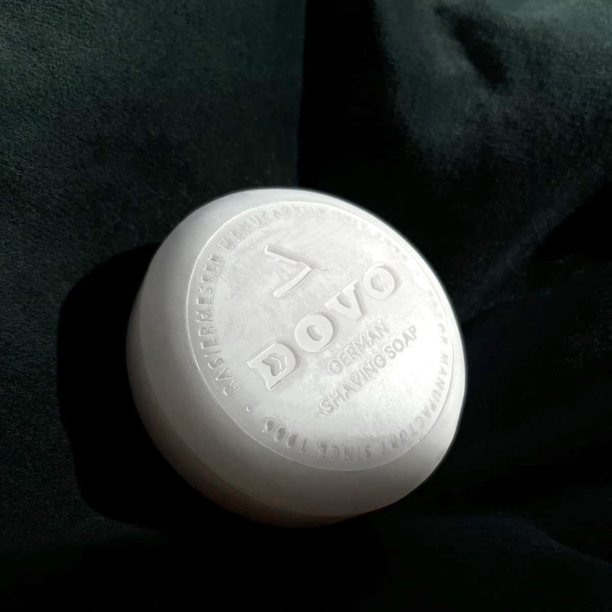 White shaving soap bar with 'Dovo' branding on a dark background