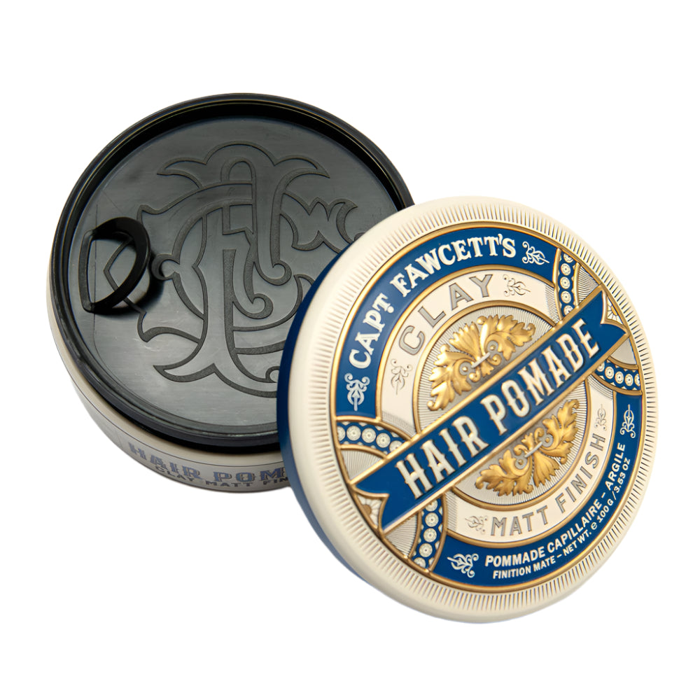 Cap and lid of a jar labeled 'Captain Fawcett's Hair Pomade' on a white background