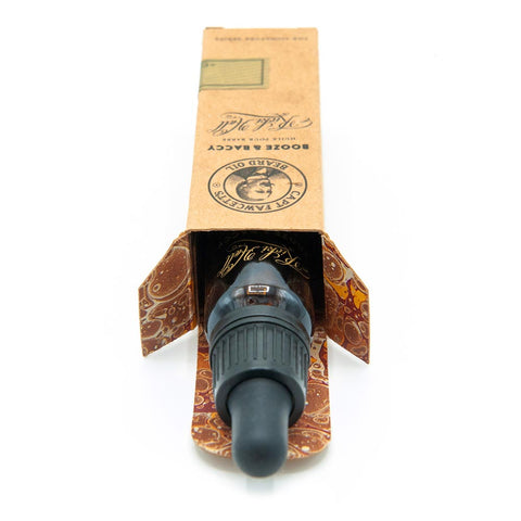 Black bottle cap with a decorative cardboard packaging on a white background