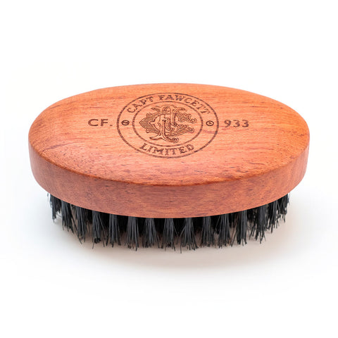 Wooden beard brush with black bristles on a white background