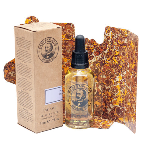 Bottle and box of Captain Fawcett beard oil with decorative packaging on a white background