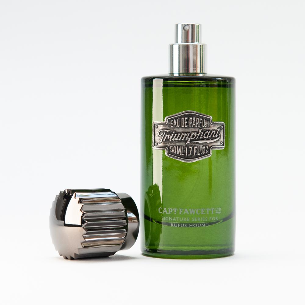 Green perfume bottle with silver cap on a white background