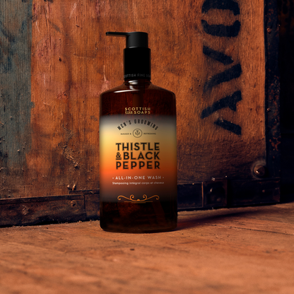 Thistle & Black Pepper All-in-One Wash pump bottle on a rustic wooden shelf