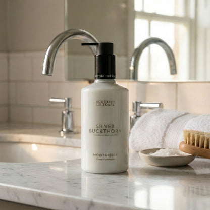 Silver Buckthorn Moisturiser pump bottle beside a bathroom basin and towels