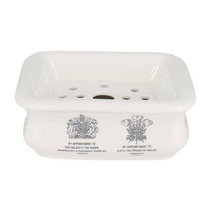 White soap dish with engraved designs on a white background