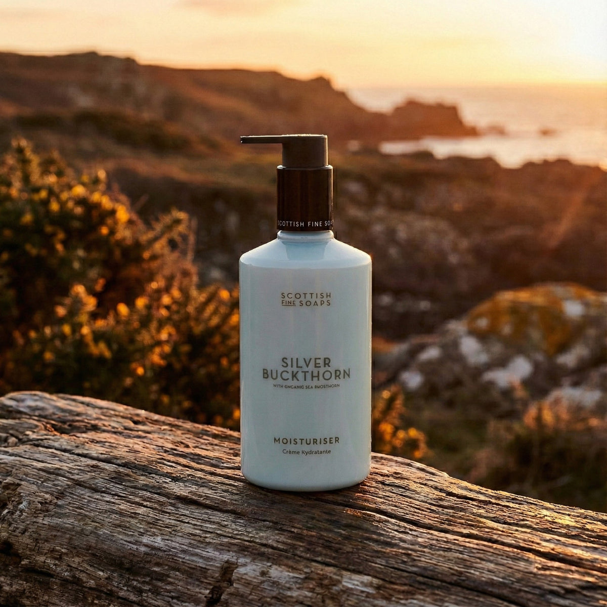 Silver Buckthorn Moisturiser bottle on weathered wood overlooking a sunset landscape