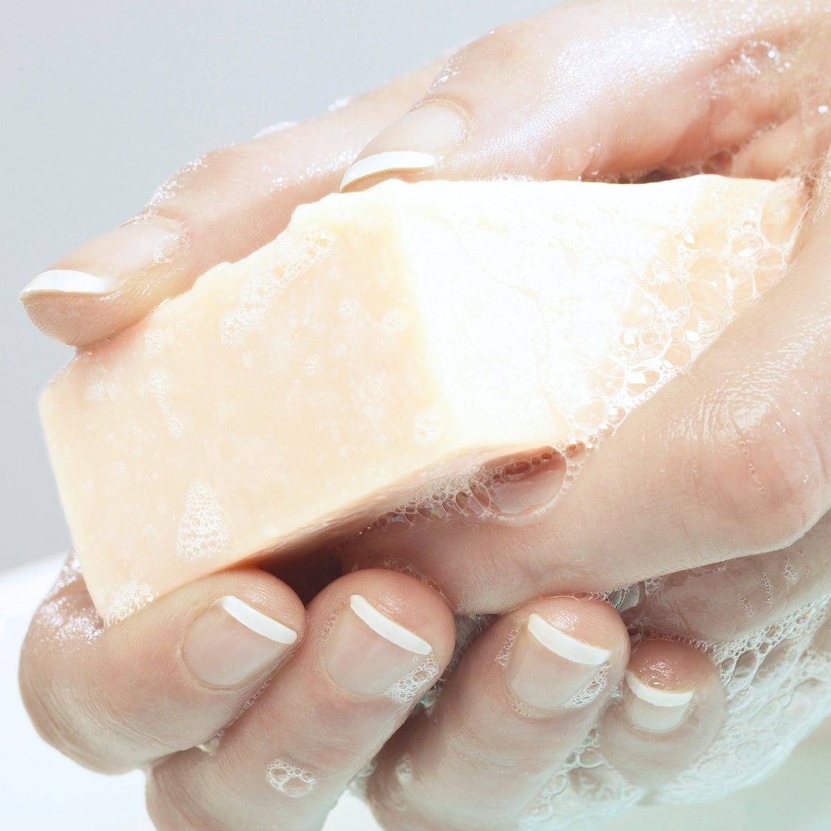 Oakmoss soap bar lathering between wet hands