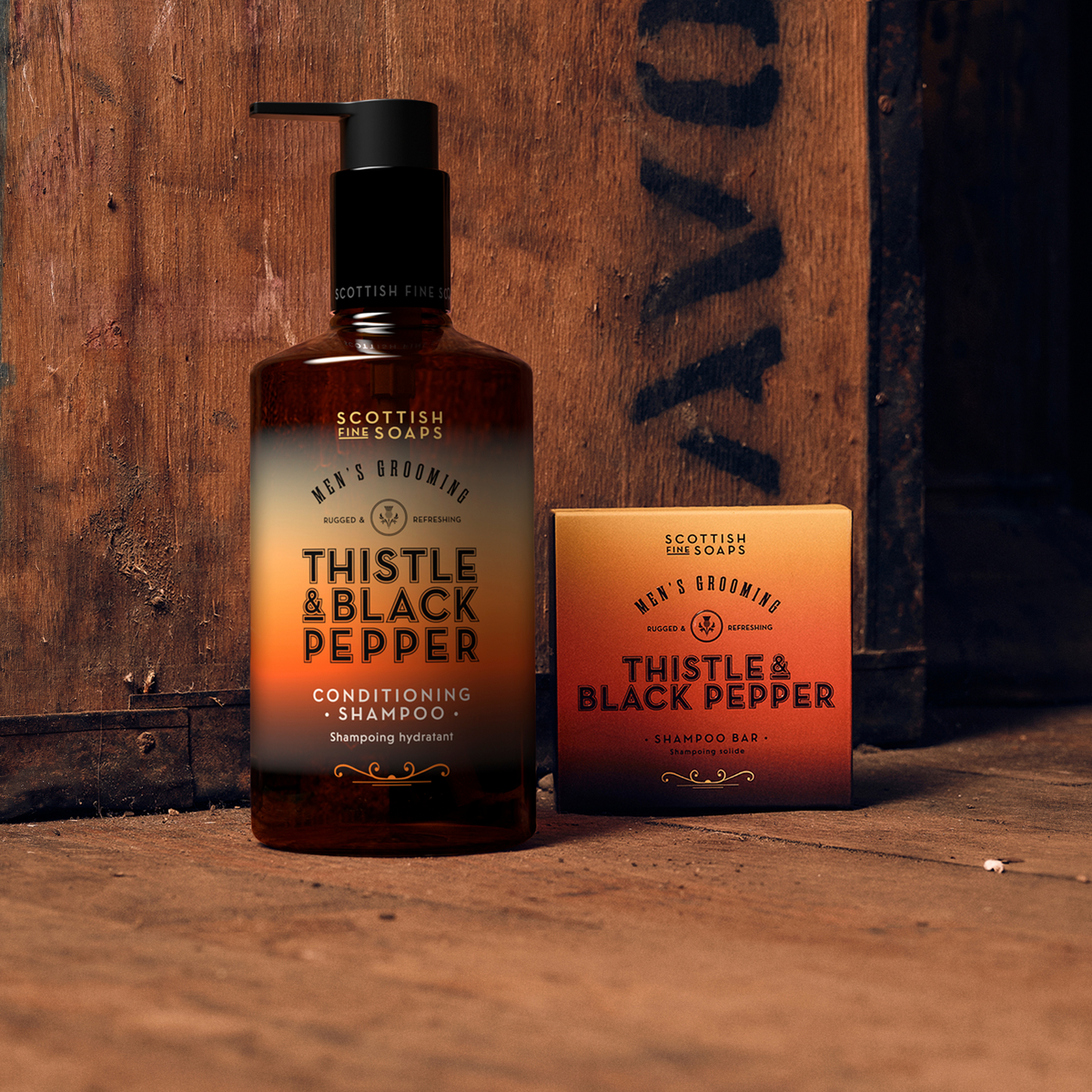 Thistle & Black Pepper All-in-One Wash pump bottle with a boxed Shampoo Bar on wood