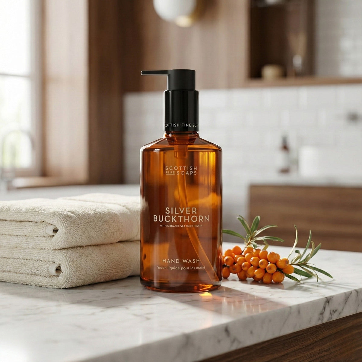 Silver Buckthorn Hand Wash beside folded towels and sea buckthorn berries