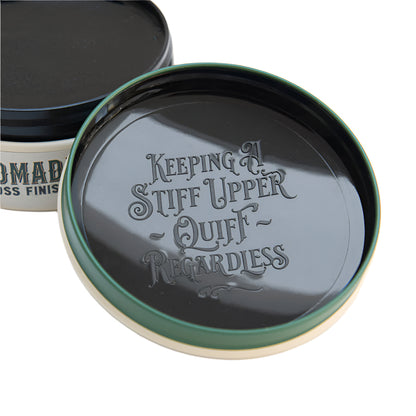 Jar lid with engraved text 'Keeping A Stiff Upper Quiff Regardless' on a white background