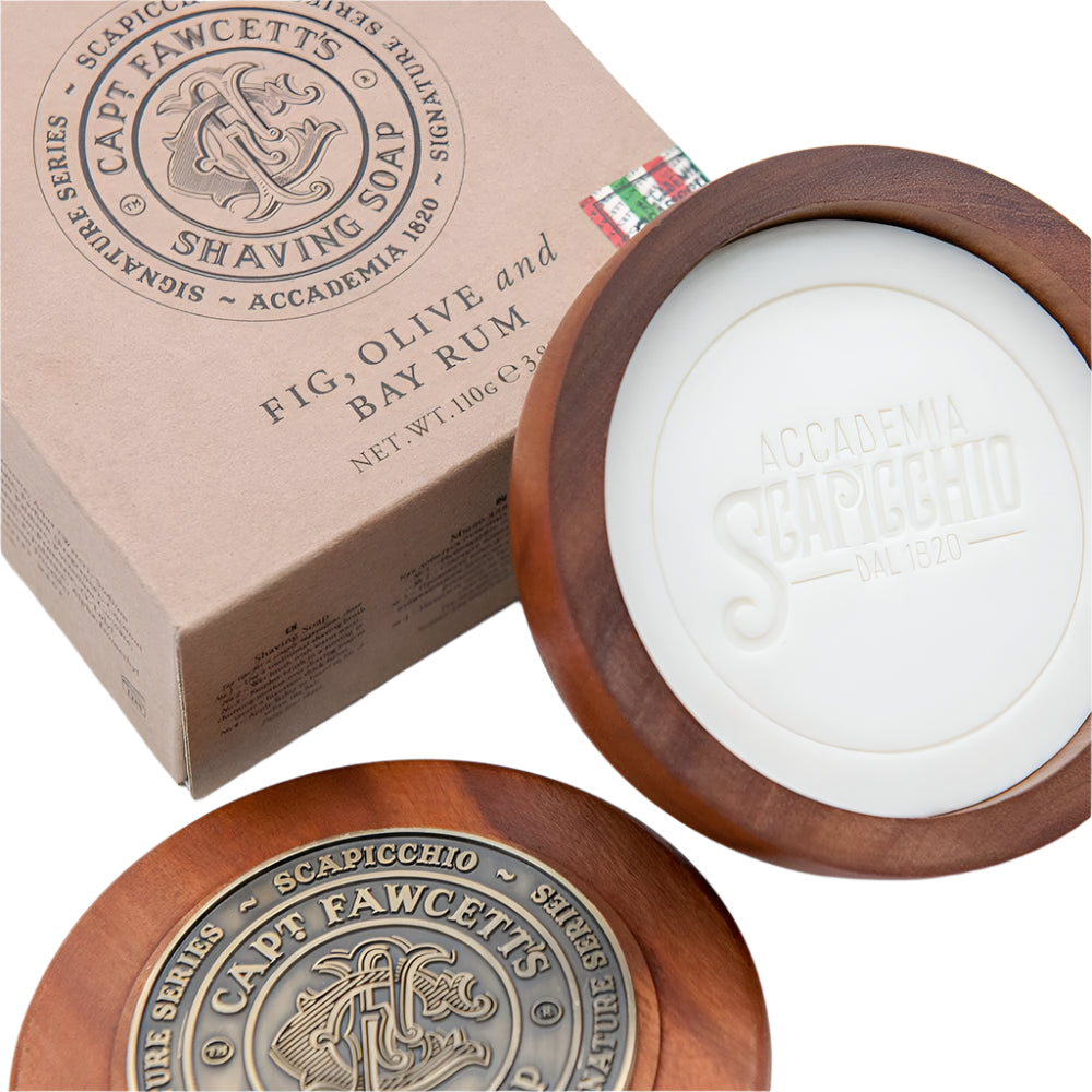 Shaving soap in a wooden bowl with packaging featuring 'Cap't. Fawcett's' branding on a white background.