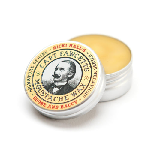 Moustache wax container with yellow wax and 'Capt. Fawcett's' branding on a white background. Captain Fawcett Booze & Baccy Moustache Wax 15ml In Aluminium Tin With Signature Tobacco Scent.