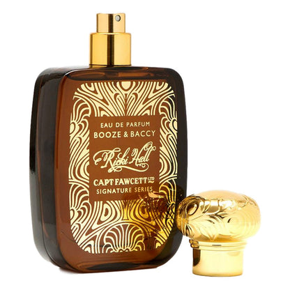 Perfume bottle with gold cap and intricate label on a white background