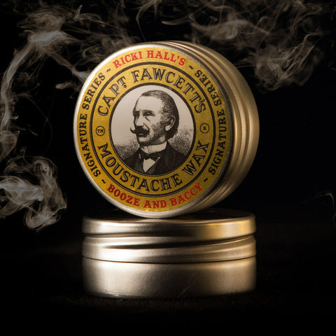 Cap't Fawcett's Moustache Wax container with a portrait of a man on a dark background