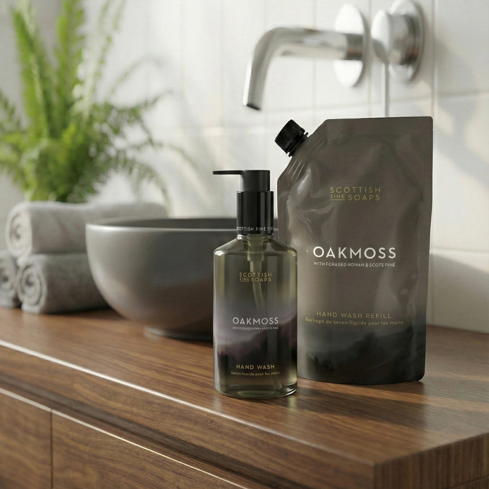 Oakmoss Hand Wash refill pouch with the matching pump bottle beside a basin