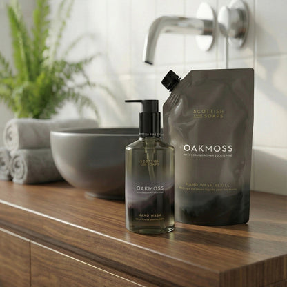 Oakmoss Hand Wash refill pouch with the matching pump bottle beside a basin