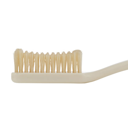 Beige toothbrush with natural bristles on a white background