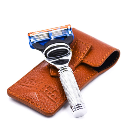 Shaving razor with brown leather case on a white background