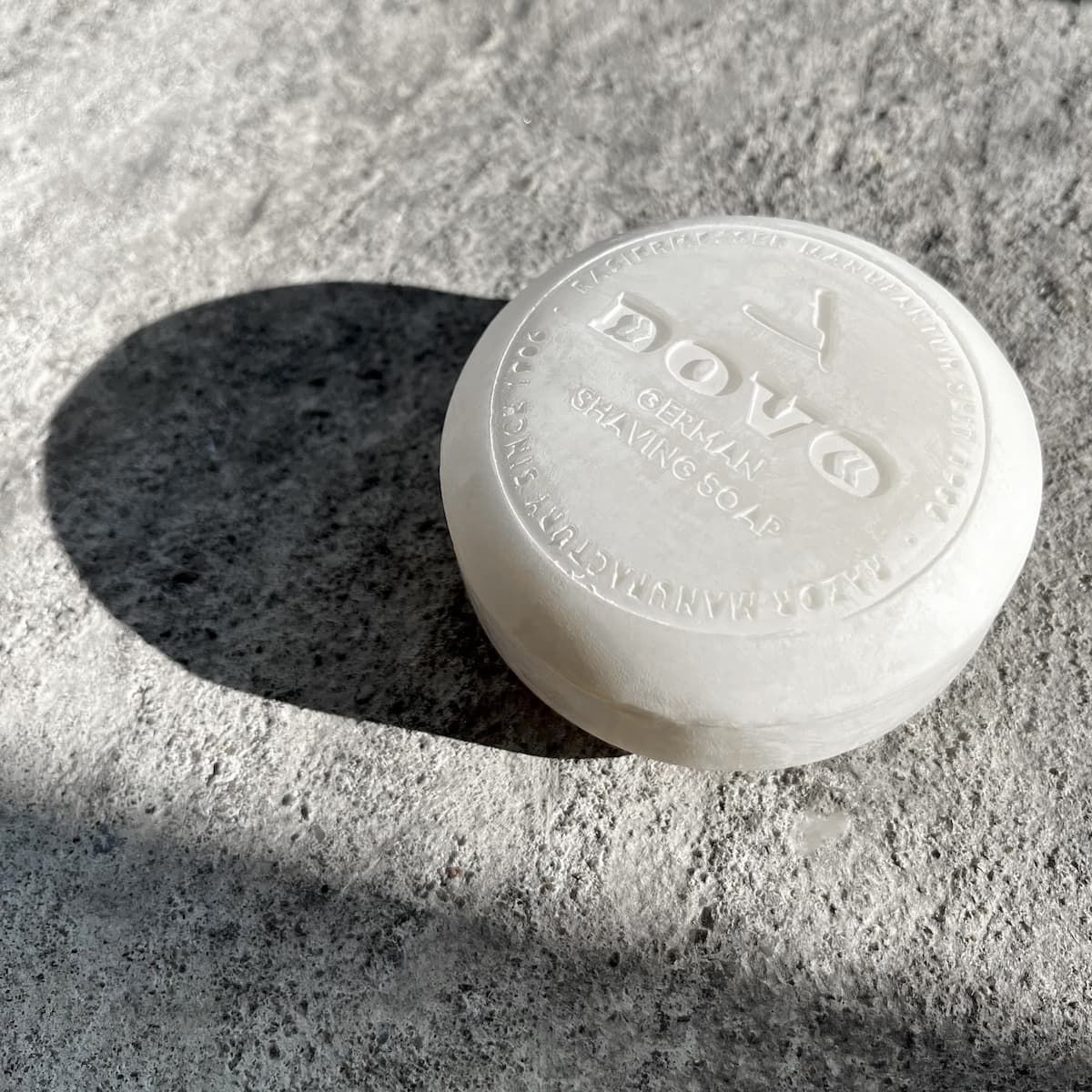 Dove shaving soap bar on a textured surface