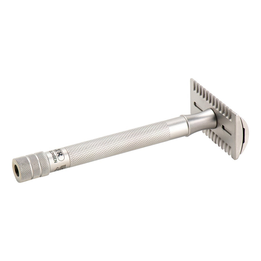 Underside angle of the Merkur 25 INOX showing the open comb teeth and satin handle.