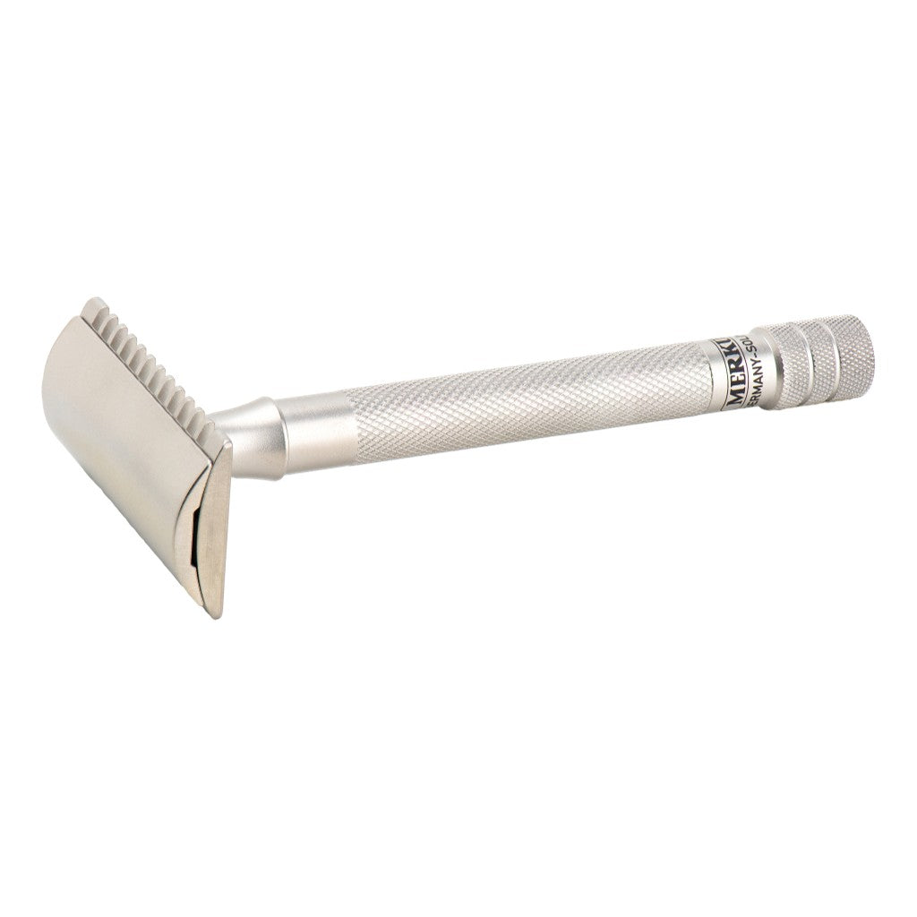 Angled view of the Merkur 25 INOX open comb head and stainless steel handle.