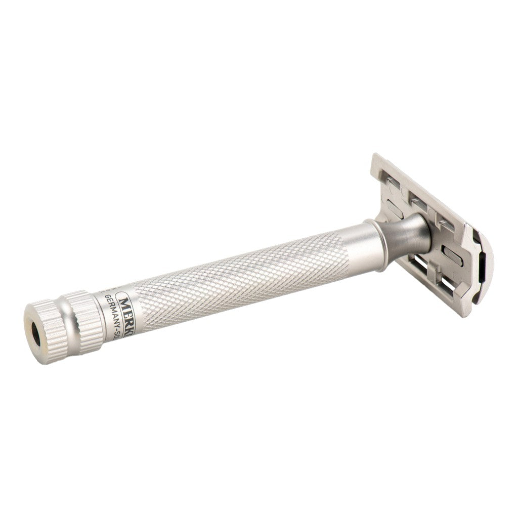 A silver stainless steel folding pocket knife shown on a plain white background, with the brand name 'MERKUR' visible on the handle.