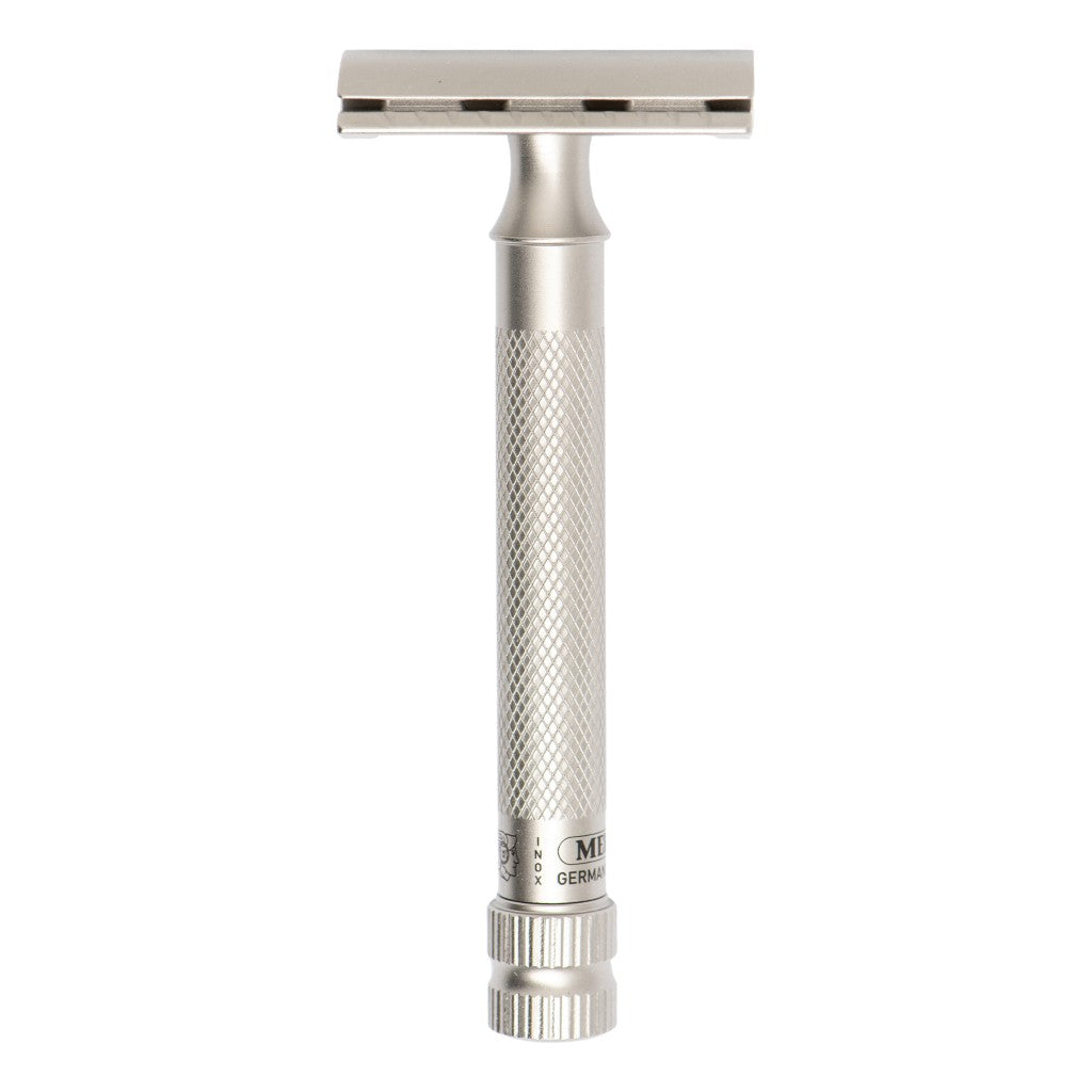 A silver stainless steel double-edge safety razor with a textured grip handle and a rectangular head, shown vertically against a plain white background.