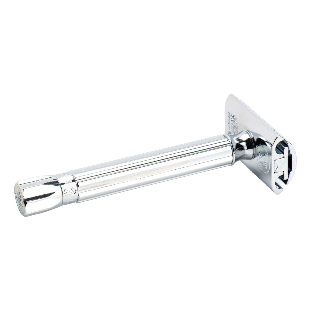 A classic safety razor with a highly polished chrome finish, shown from a side profile view against a plain white background.