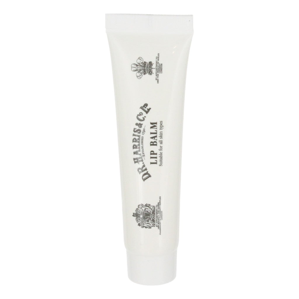 White lip balm tube with black text and logo on a white background. D.R. Harris Lip Balm Tube – 15g Soothing Menthol And Cocoa Butter Formula.