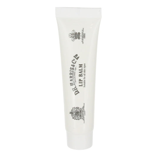 White lip balm tube with black text and logo on a white background. D.R. Harris Lip Balm Tube – 15g Soothing Menthol And Cocoa Butter Formula.