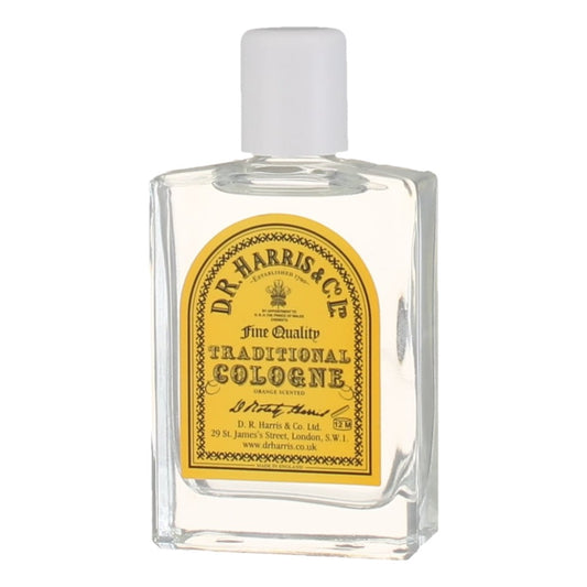 Clear cologne bottle with yellow label on a white background