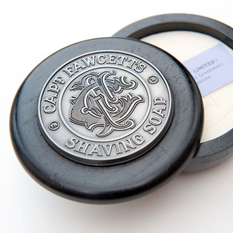 Cape Fawcett's shaving soap with black lid on a white background