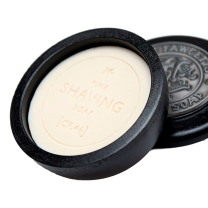 Shaving soap bar in a black wooden bowl with 'Fine Shaving Soap' branding.