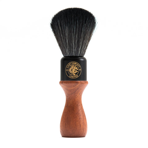 Shaving brush with black bristle head and wooden handle on a white background