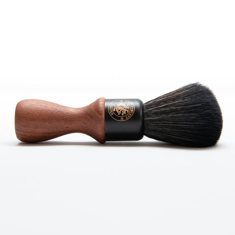 Shaving brush with wooden handle and black bristles on a white background
