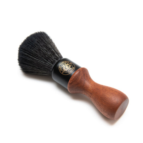 Shaving brush with black bristles and wooden handle on a white background